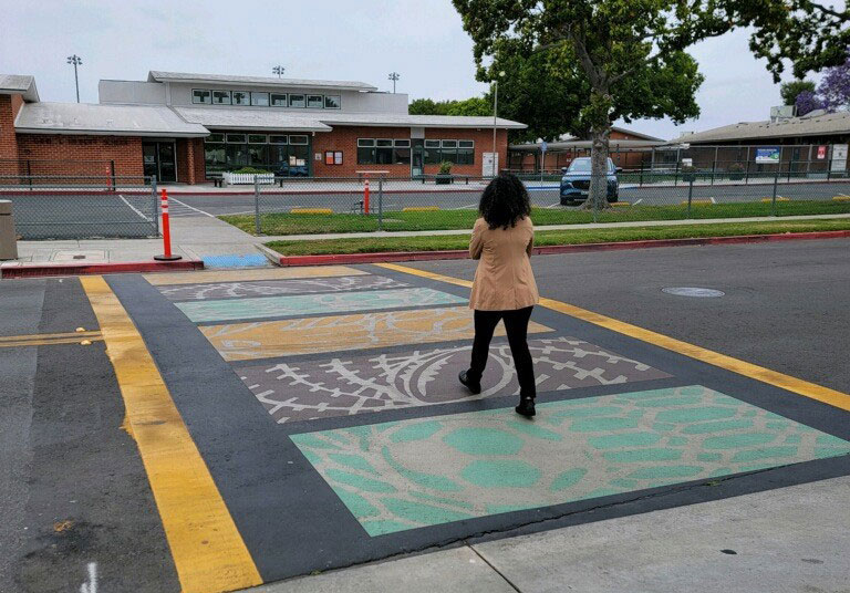 woman walking across crosswalk