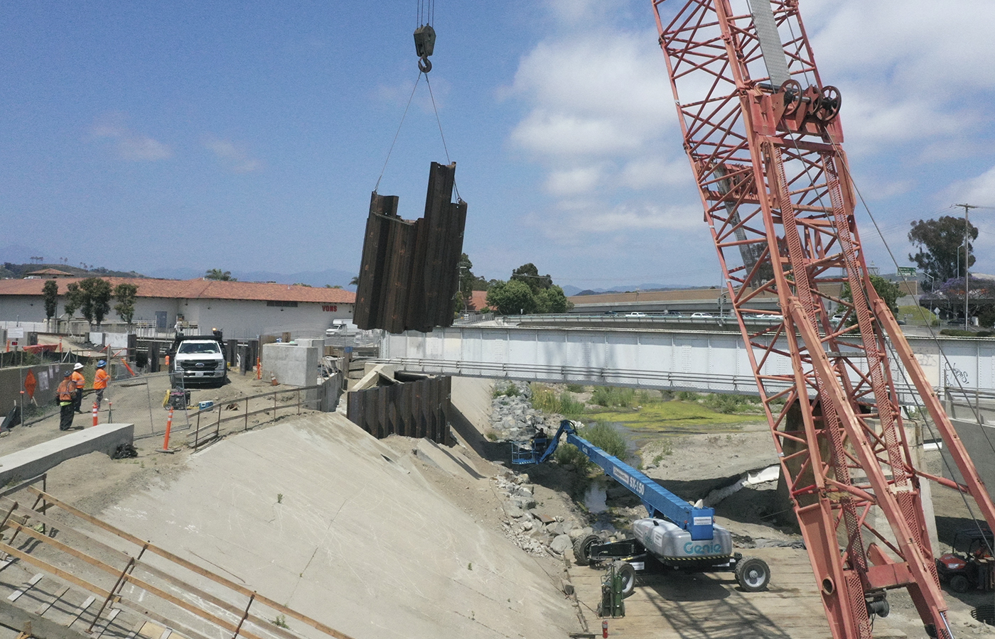 Crews hoisting sheet piles parts that were cut off