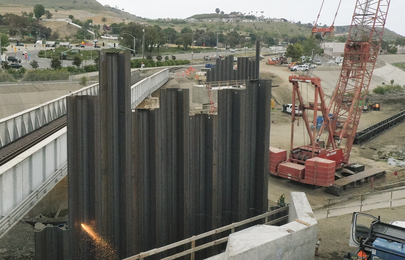 Crews torch cutting sheet piles.