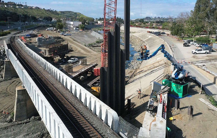 Contractors installing sheet pile walls.


