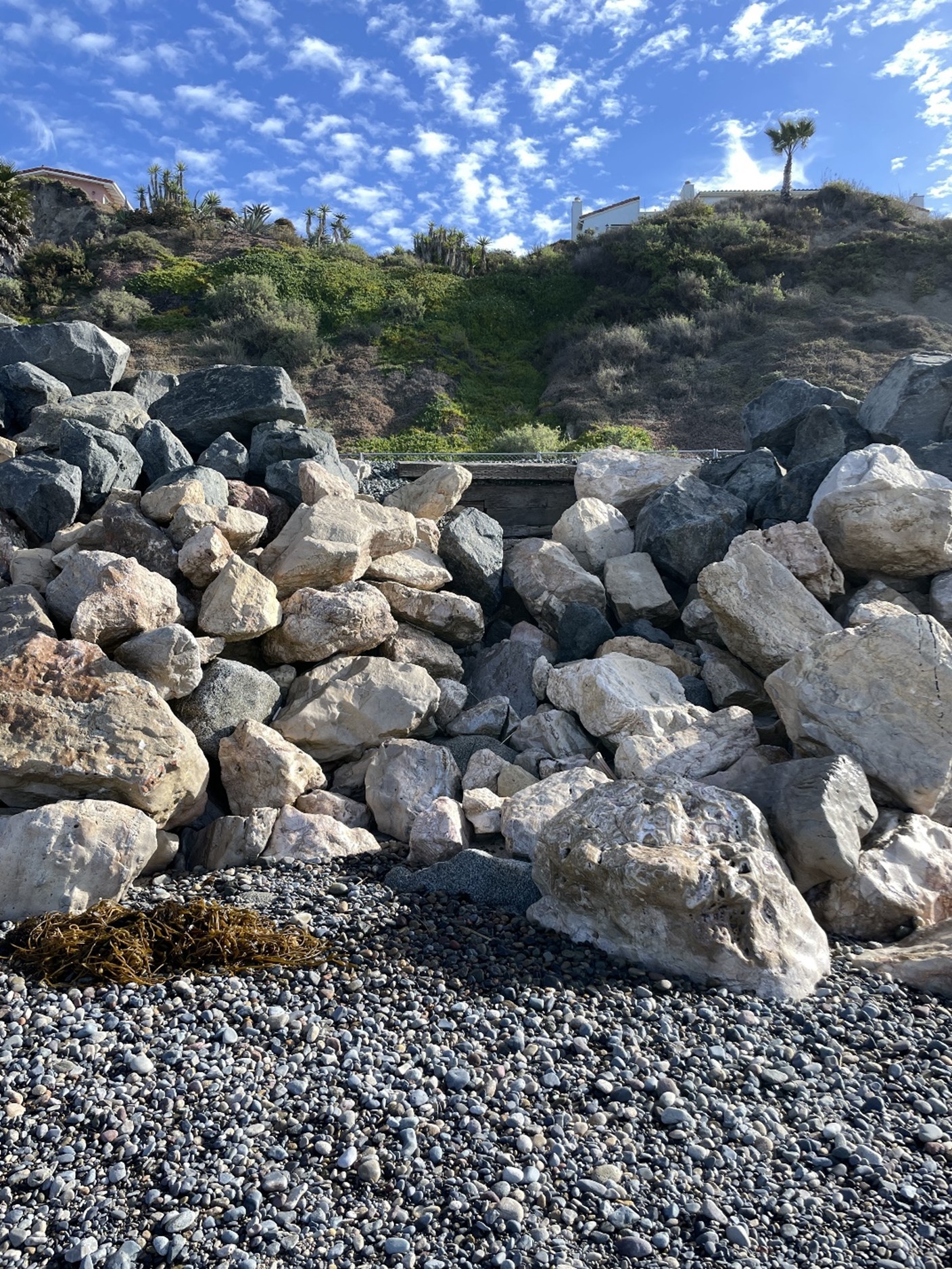 Undersized stones, exposed ballast and no crest protection at culvert outfall
