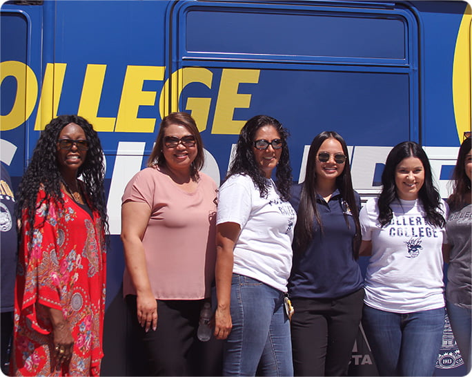 A group of college students standing in front of OCTA's community college bus